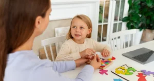 Therapist and child in autism therapy session.