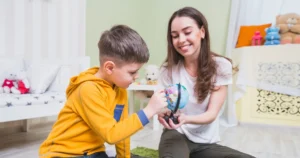 ABA therapy session with therapist teaching a child through interactive learning activity.