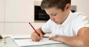 Child practicing handwriting in a notebook.