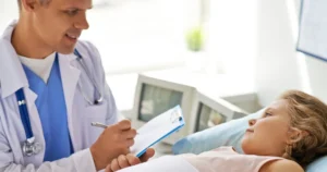 Doctor consulting a child during an endoscopic examination.
