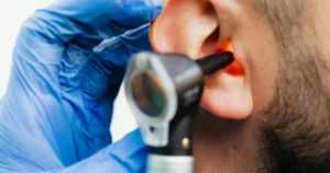 ENT specialist examining a patient’s ear