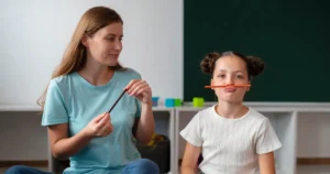 Therapist guiding a child during a speech therapy activity.